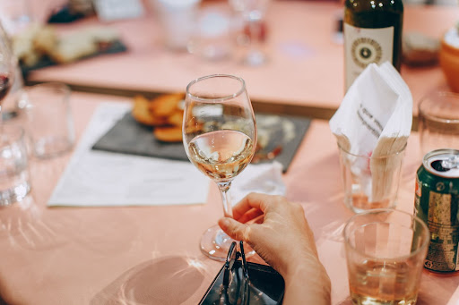 Close up on a glass of white wine as part of a table setting