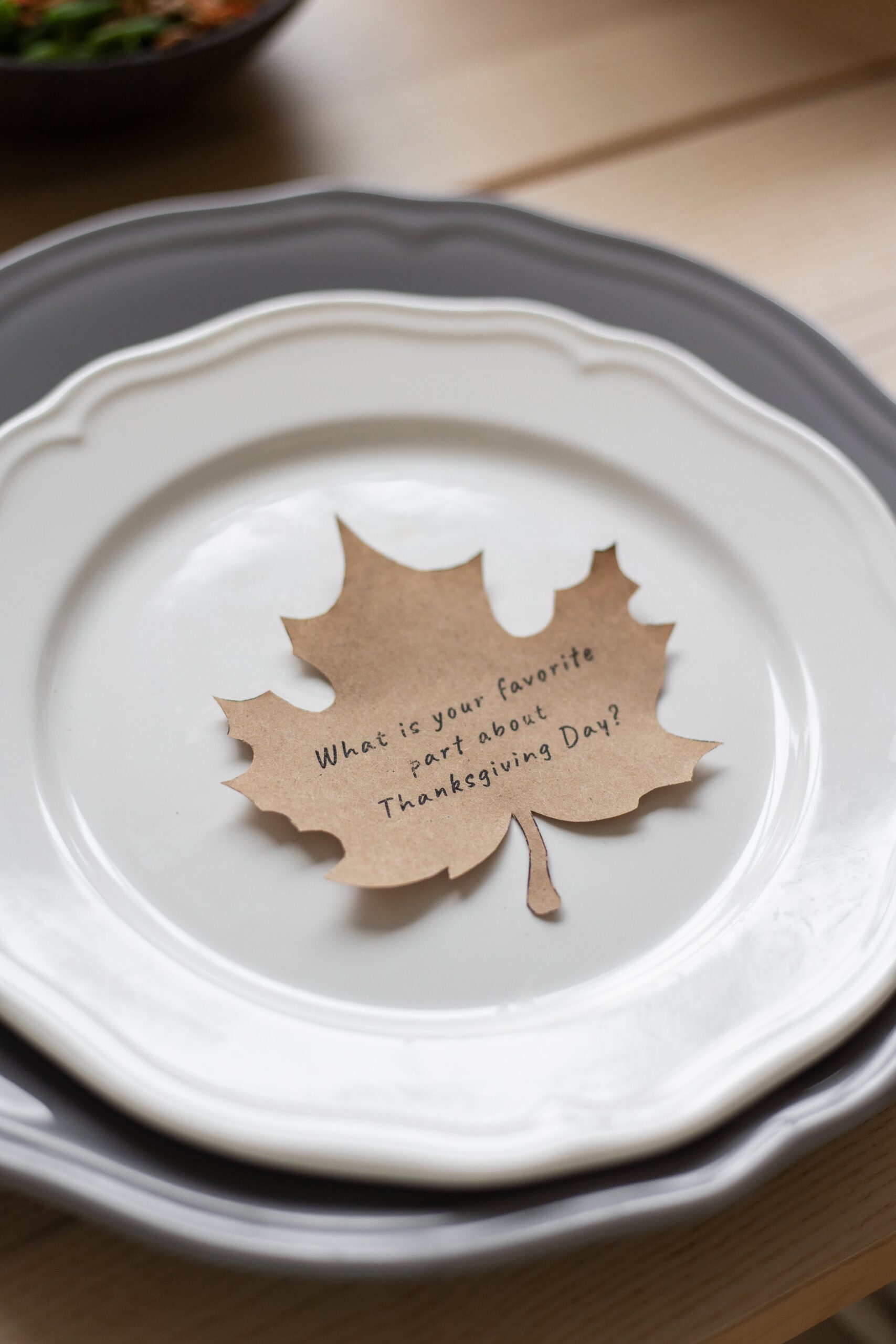 One fall decorating idea is having a paper leaf cutout and sitting on the plate